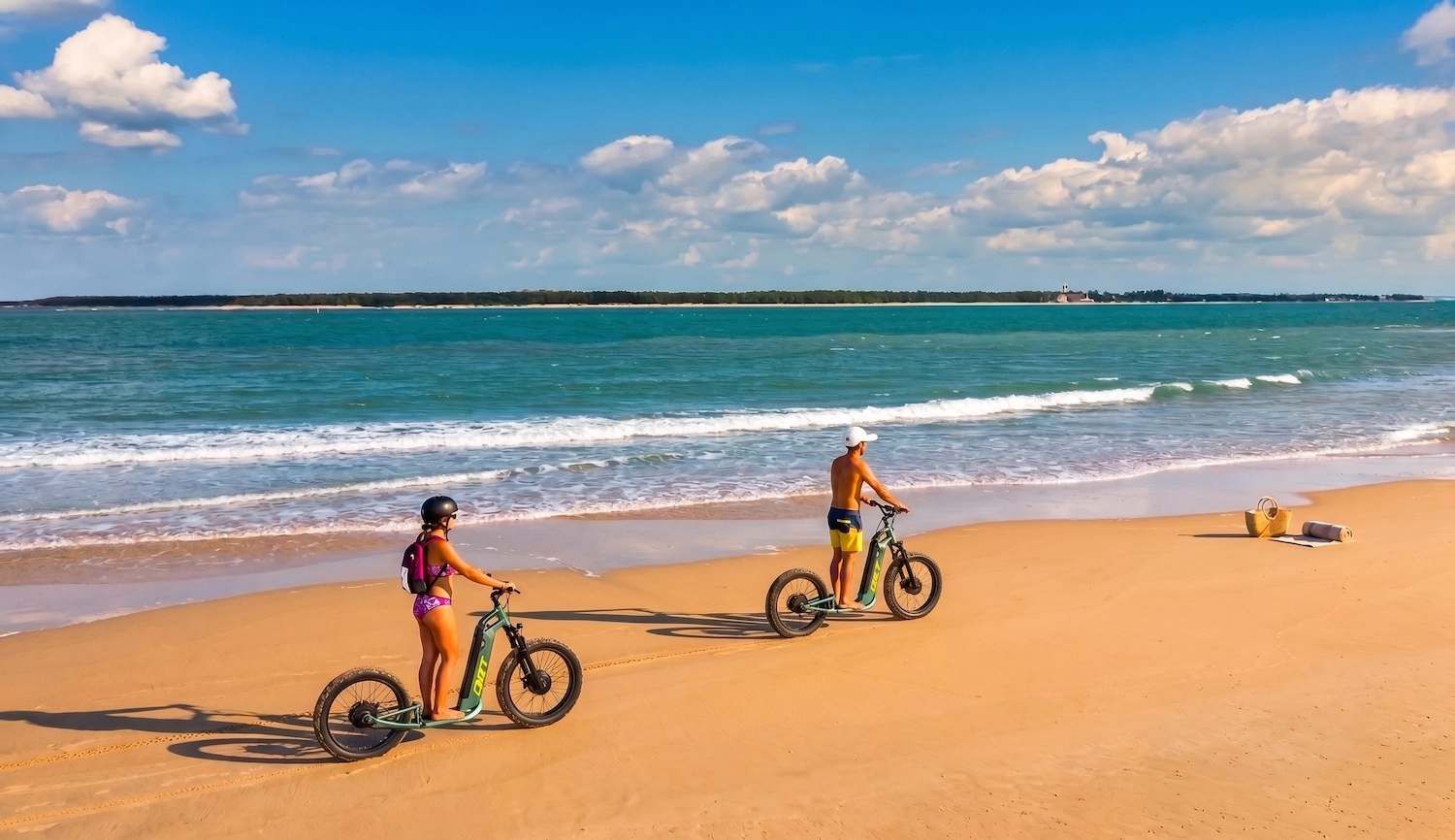 Deux personnes en trottinette électrique sur la plage de sable doré de Ronce-les-Bains en Charente-Maritime