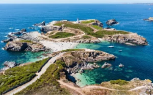 Vue aérienne d’une pointe bretonne avec phare et eaux turquoise en Bretagne Finistère